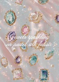Jewels sparkling on pastel silk fabric