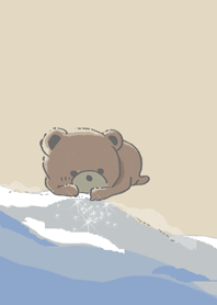Little bear playing with the waves