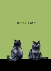 Two black cats on moss green
