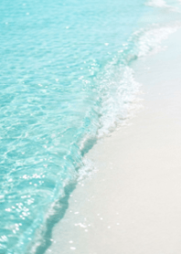 Crystal Clear Waves on White Sand Beach